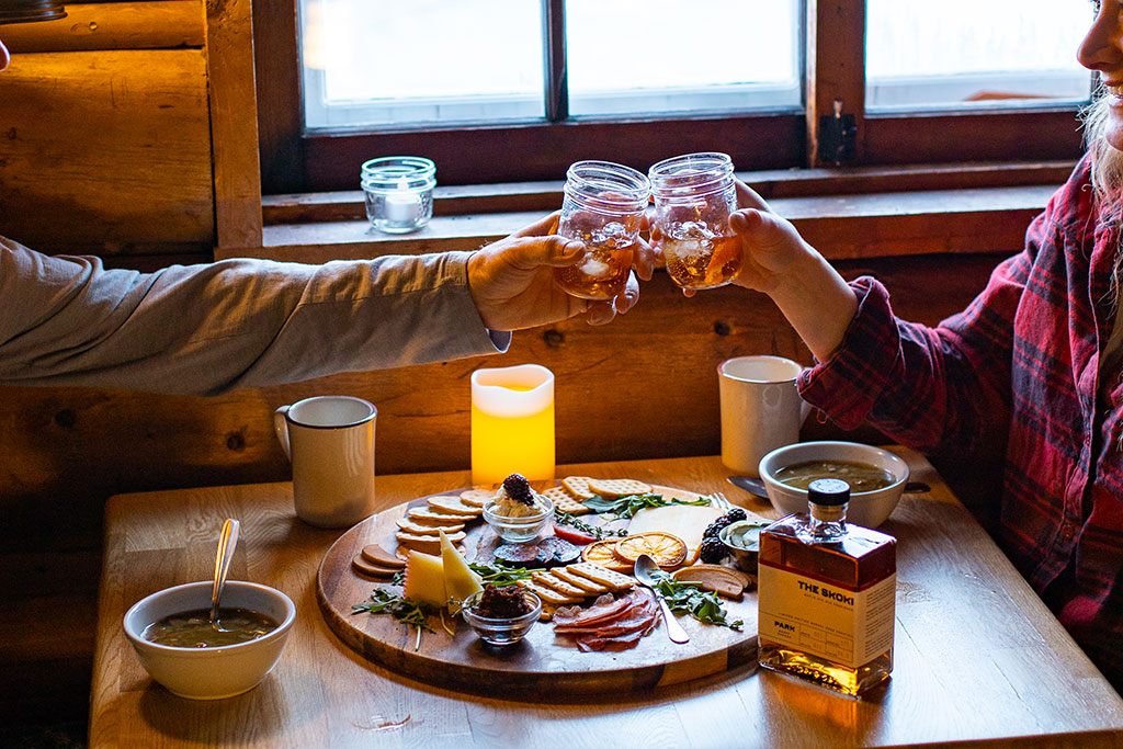 Guests enjoying charcuterie and drinks in the lodge