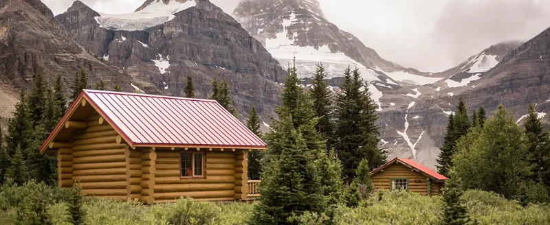 Log cabin exterior with Mount Assiniboine backdrop