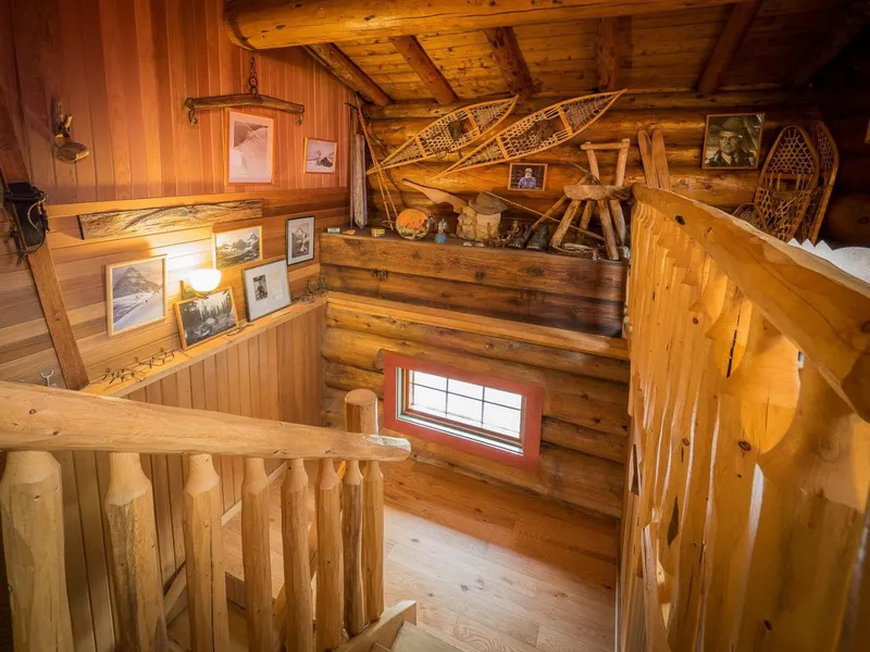 Historic staircase with snowshoes and photos