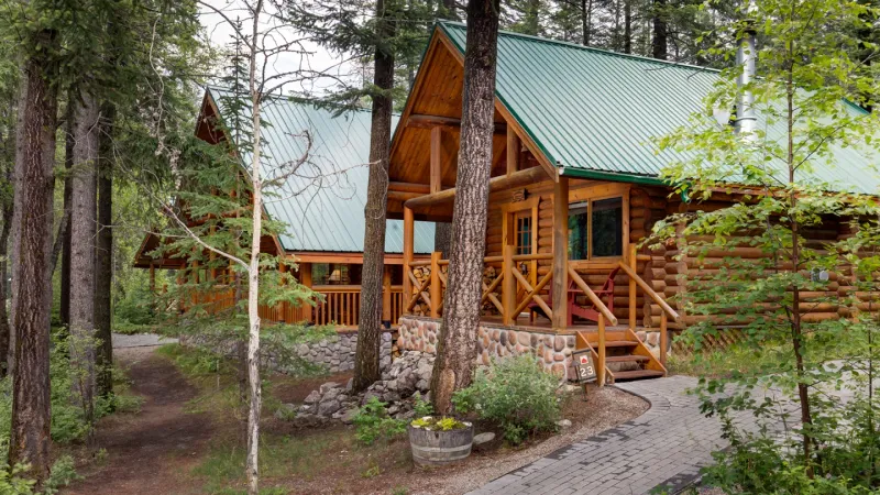 Cathedral Mountain Lodge exterior with cabins along the Kicking Horse River