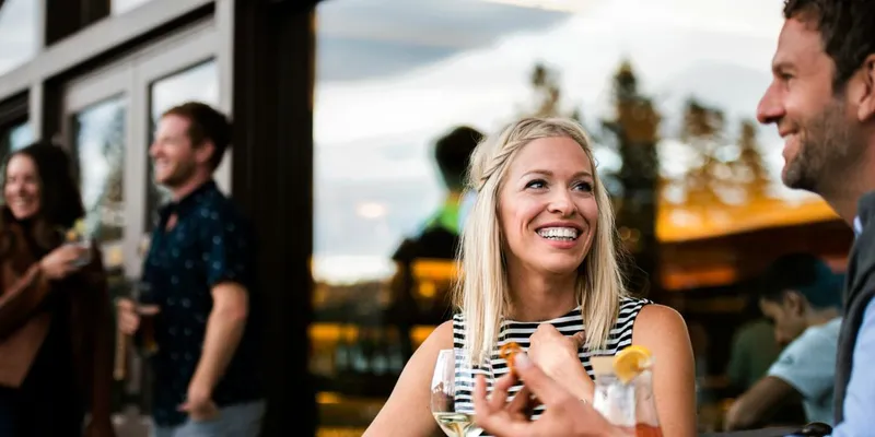 Fairmont Jasper Park Lodge dining room with large windows overlooking mountains and forest landscape.