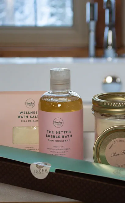 Prairie Creek Inn romance package amenities displayed on bathroom counter with bath products and window view.