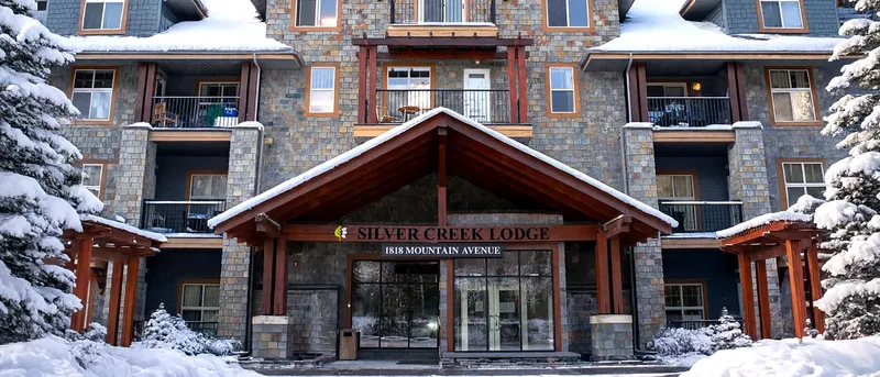 Silver Creek Lodge entrance in winter with snow-covered building