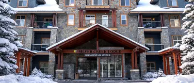 Silver Creek Lodge entrance in winter with snow-covered building