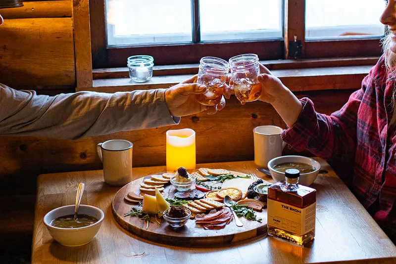 Guests enjoying charcuterie and drinks in the lodge